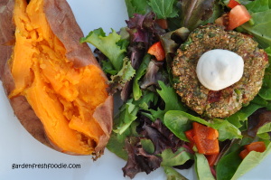 Grain Free Cauliflower Burger Atop Salad Served With Baked Sweet Potato
